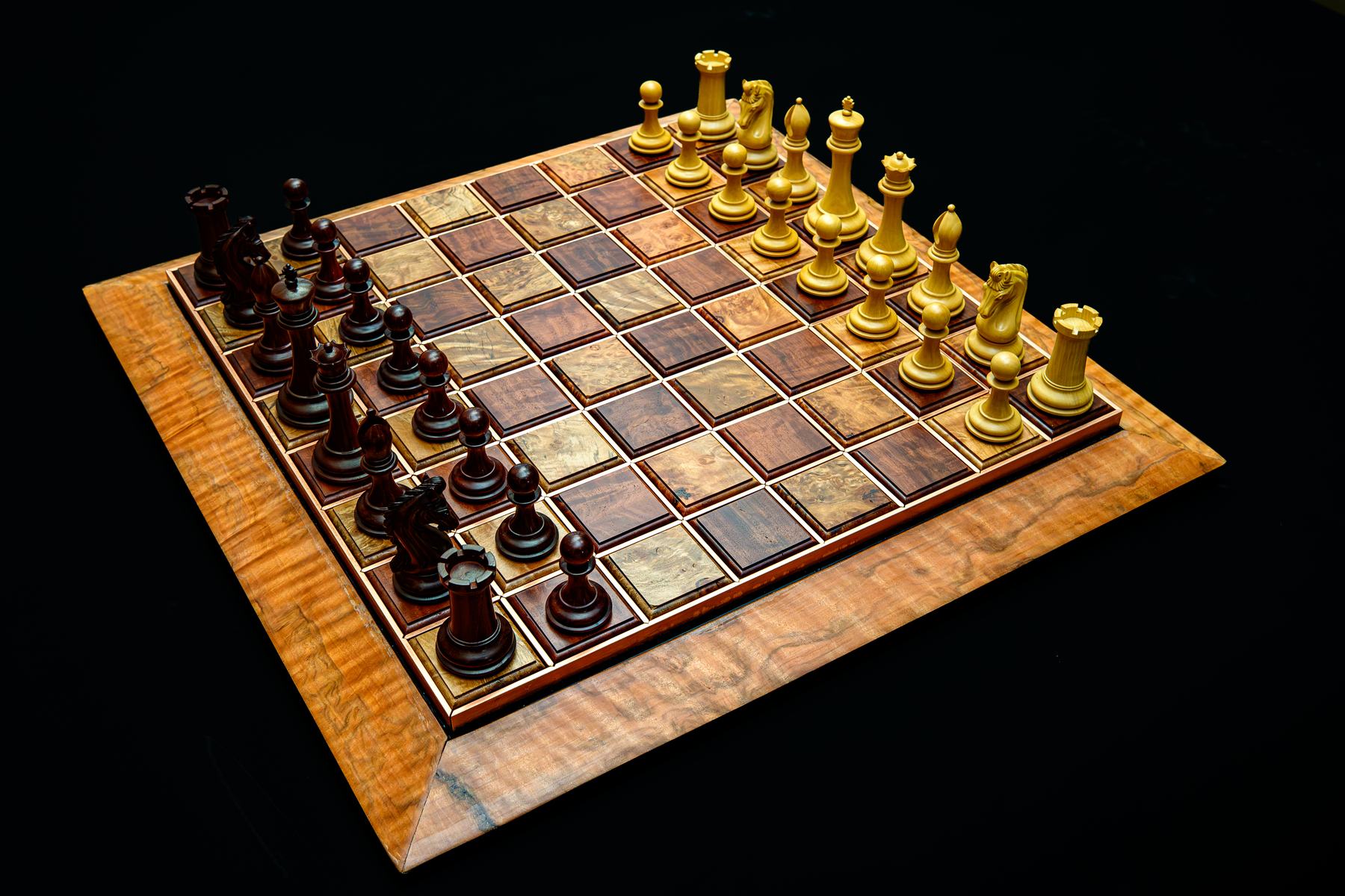 Chess pieces mid-game on the Jarrah and Tasmanian Rose Myrtle board, viewed at an angle